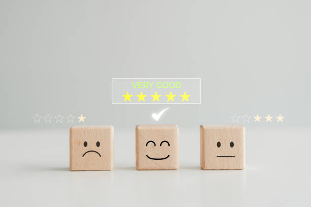 istock Select happy face wooden cube with 5 star. Customer service rating experience, review, feedback, emotion and satisfaction survey. Choosing positive attitude. World mental health day. 1654262035