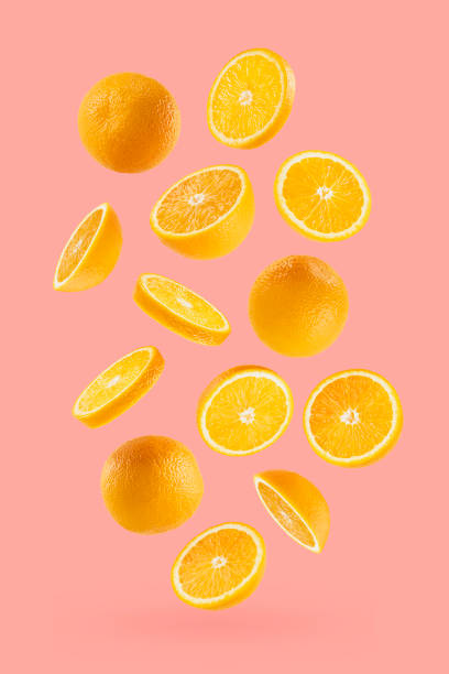 istock Bright oranges as flow fly or fall as art composition. Whole, half, round slices fruits on pastel pink background with shadow. Tropical fruits for advertising, design, label product, poster, card. 1654282629