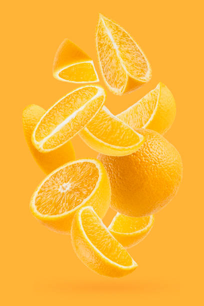 istock Bright oranges closeup levitation as flow, art composition. Whole, half and quarter pieces fruits on pastel orange background with shadow. Summer fruits for advertising, design, label product. 1654282630