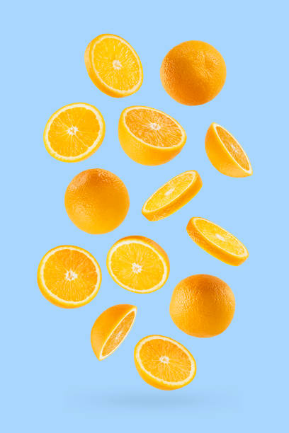 istock Bright oranges as flow fly or fall as art composition. Whole, half, round slices fruits on pastel blue background with shadow. Tropical fruits for advertising, design, label product, poster, card. 1654282643