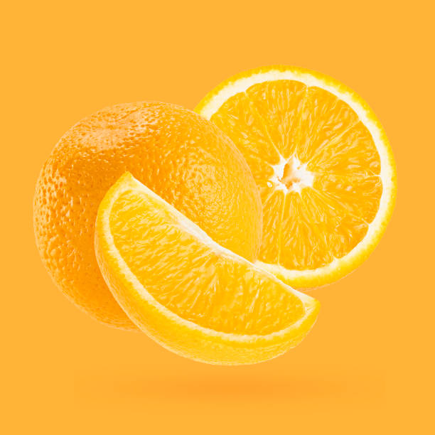 istock Bright oranges closeup levitation as art composition. Whole, half, quarter piece fruits on pastel orange background with shadow. Fruits for advertising, design, label product. 1654282826