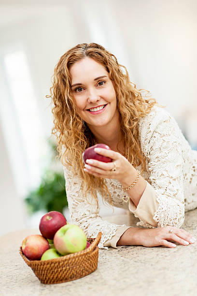 istock Smiling woman holding apple 165429011