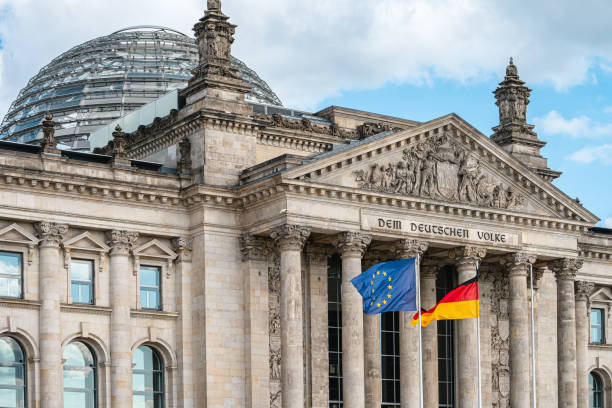 The flags of the european union and germany waving in the wind in front of the reichstag in berlin image of the German parliament building bundestag stock pictures, royalty-free photos & images