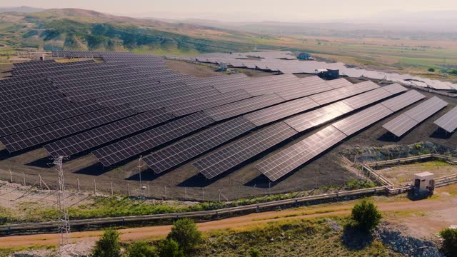 [Z05] Photovoltaic Power Station - Aerial View of Solar Panels Farm - Field of Green Renewable Energy - Slow Motion 50 fps Drone Shot