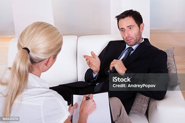 Man Talking To His Psychiatrist Stock Photo - Download Image Now - Above, Adult, Assistance