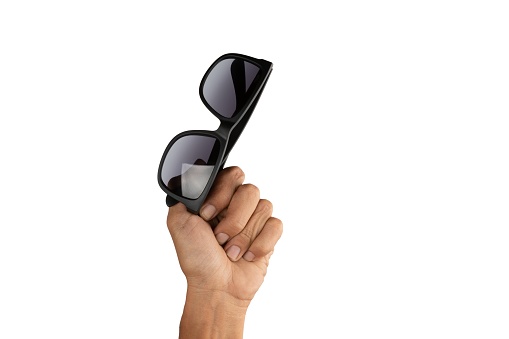 isolated hand holding sunglasses on white