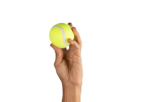 a hand holding a tennis ball isolated