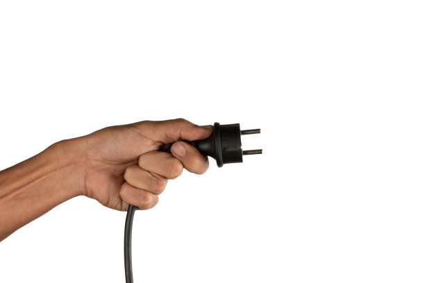 Power plug in a hand on a white background