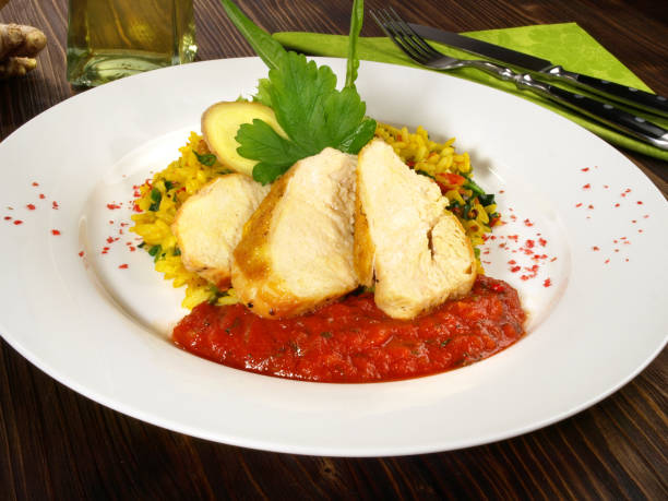 istock Corn fed Poularde - Chicken Breast with Curry Rice and Tomato Sauce 1654329947