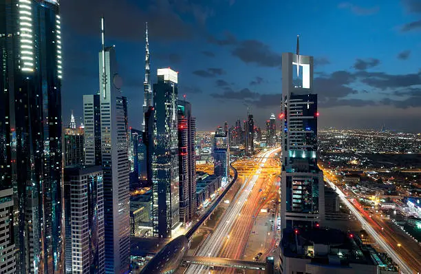 illuminated skyscrapers along Sheikh Zayed Road, Burj Khalifa and Burj Al Arab Hotel at night in Dubai United Arab Emirates