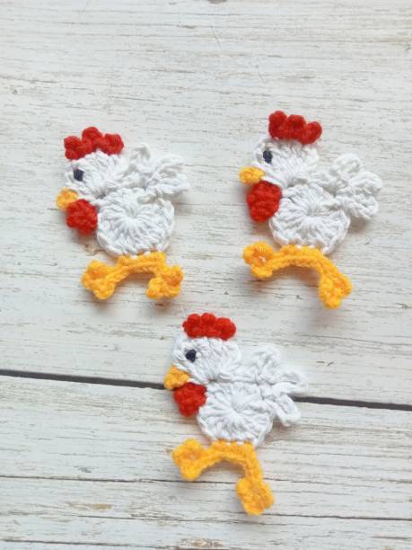 istock Crocheted Chicken Garland Handmade knitting for decoration background texture 1654374667