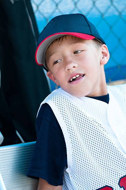 istock Little league baseball player in dugout 165438014