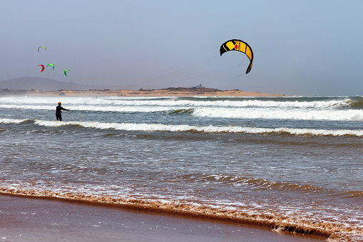 Essaouira, Morocco - June 10, 2017: Kiteboarding activities on the Atlantic ocean waves in the Essaouira.