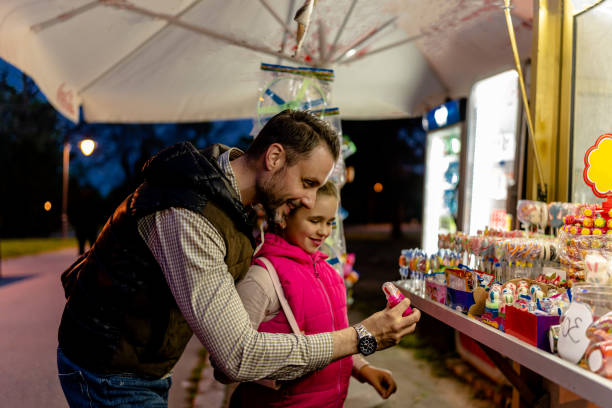 istock Father and Daughter Choose Lollipops Together 1654402131