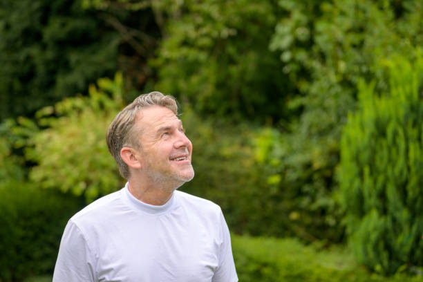 istock Middle age man looks to the sky with a joyful smile 1654438355