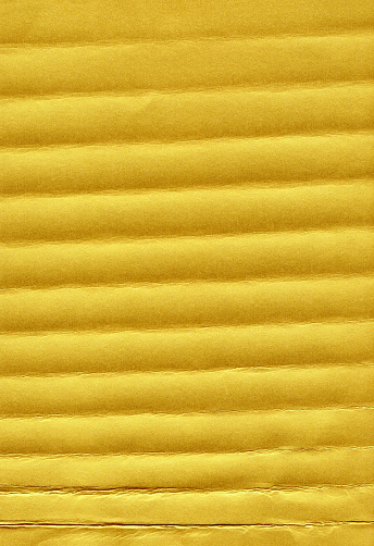 Horizontal creases on crumpled gold sheet of paper texture