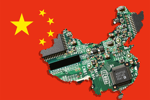 Electronic Circuit Board with microchips in form of map of China over Flag of China. Concept for world supremacy in microchip and semiconductor manufacturing.