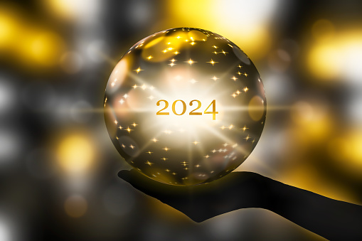 fortunetelling 2024 with a golden crystal ball in a hand, festive atmosphere for happy new year party or award ceremony or other holiday celebrations, 3d illustration