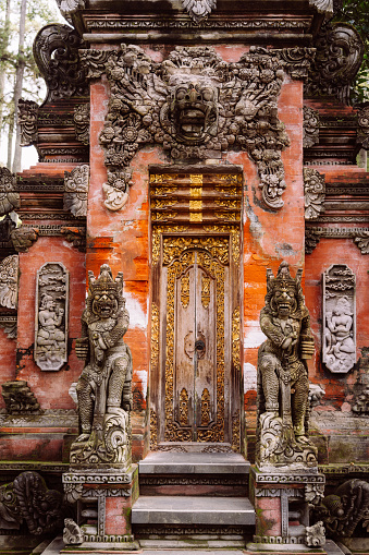 Traditional balinese handmade carved wooden door. Bali style furniture with ornament details\n\nTirta Empul temple is an ancient Hindu Balinese water temple located near the town of Tampaksiring, Bali, Indonesia.