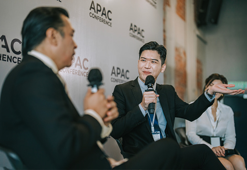 Panel Discussion Asian business person discussion on stage during business conference seminar