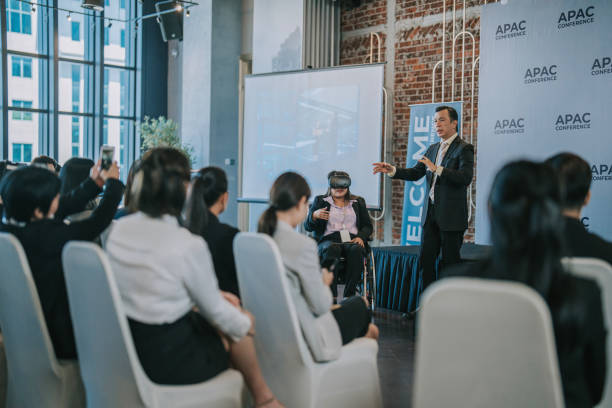 Asian Entrepreneur explaining demonstrate to business conference participants on VR google functionality  in workshop