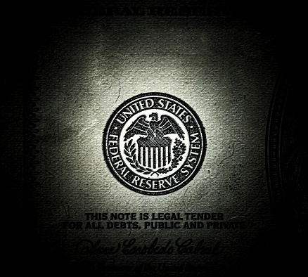 Symbol of the US Federal Reserve System on the old US 100 dollar bill. Fed emblem close-up on american currency. Macro grunge style photo.
