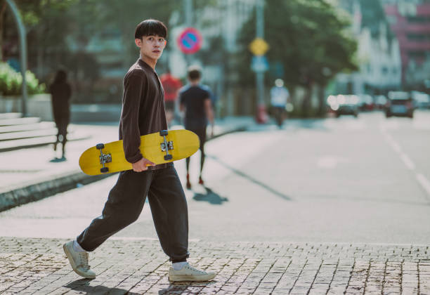 istock Skateboarding Through the City: A Young Asian Commuter 1654537117