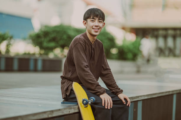 istock Cityscape Cruiser: Journey of a Young Asian Skateboarder 1654538874