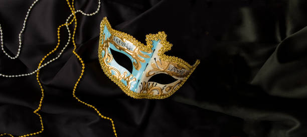 istock Christmas carnival mask on the on the black textile background. Top view. Copy space. 1654548687
