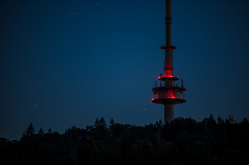 Red illuminated TV tower at night in Bielefeld