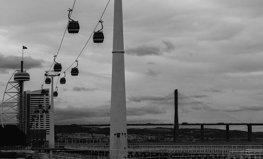 Lisbon, Portugal - Sept 1 2023: View of Gondola ride at Park of The Nations in Lisbon, Portugal with Vasco da Gama bridge in the background