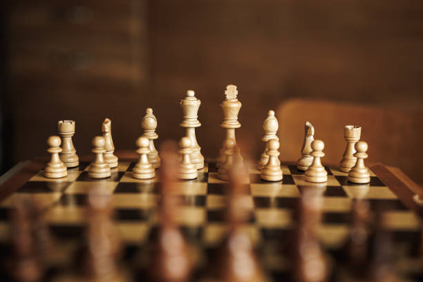 istock Wooden chessboard with set of chess pieces on table 1654604653