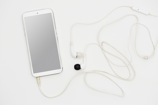 Smart phone mockup with headphones on white background