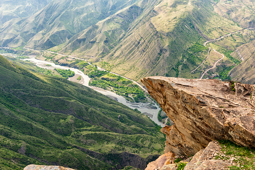 Dagestan, the area of the old abandoned village of Goor. A deep canyon with a fast mountain river flowing along its bottom. above the canyon, at a high altitude, there is a stone ledge, which among the locals is called the troll tongue.
