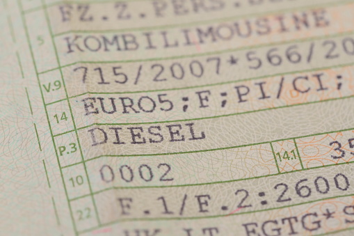 a diesel vehicle registration document with a red pen