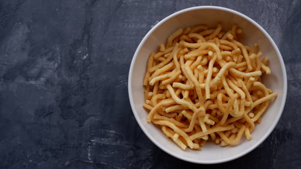 istock Cheese stick snack crackers on a white bowl. 1654686694