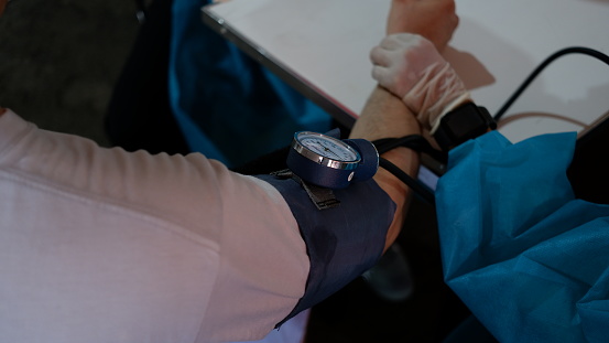A man measurement of blood pressure before vaccinating.