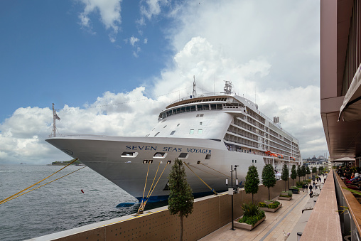 Istanbul, Turkey - May 5, 2023: Seven Seas Voyager, Large cruise ship docked at terminal of Galataport, a mixed use development located along shore of Bosphorus strait, in Karakoy neighbourhood