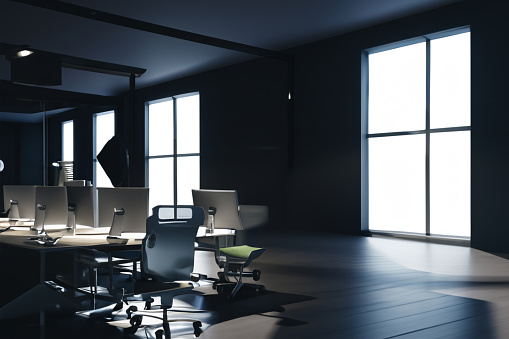 Captivating office space bathed in soft, moody dark light, exuding an ambiance of focused creativity and modern elegance.