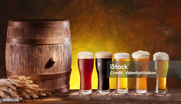 Assortment Of Beer Glasses With A Wooden Barrel Stock Photo - Download Image Now - Beer - Alcohol, Variation, Alcohol - Drink