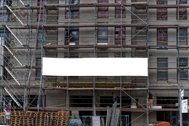 istock Advertising banners on a scaffolding of a new construction site. 1654767076