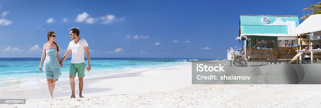 Coppia su una spiaggia tropicale - Foto stock royalty-free di Relazione di coppia