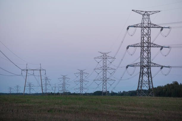 Tall electricity pylons. Powergrid, transmission tower and energy crisis. stock photo
