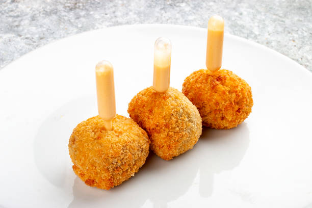 istock Cheese balls deep-fried with white sauce. Isolated image on a white background. 1654799114