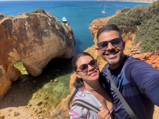 istock Couple taking a selfie on Algarve beach 1654842533