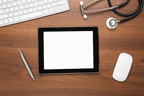 istock Top view of blank screened tablet on wooden desk 165484678