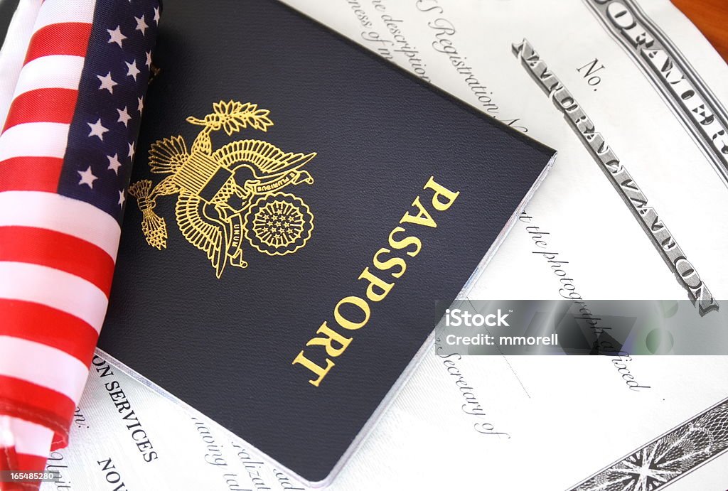 Citizenship documents Immigration concept, US passport and flag over a citizenship and naturalization certificate Emigration and Immigration Stock Photo