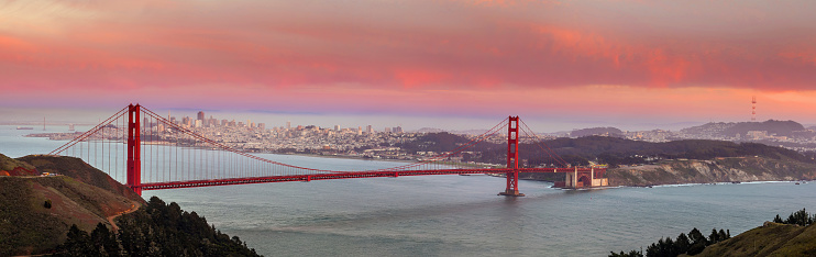 Panorama view of Golden Gate Bridge and downtown San Francisco at sunset