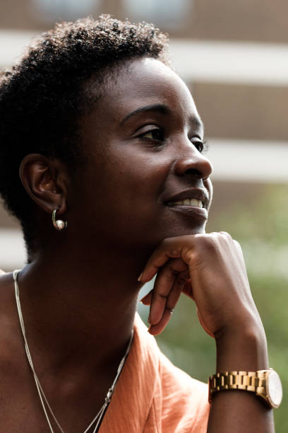 istock Confident black woman looking away outside. 1654870287