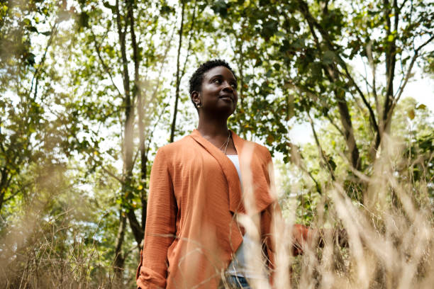 istock Black woman standing in a forest. 1654870811